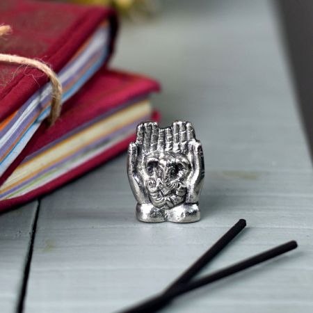Brass Lord Ganesha Sitting On Hand Statue In Silver Finish 